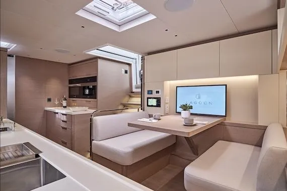  Yacht Photos Pics Luxurious interior of 2026 Lagoon SIXTY 7 yacht with modern kitchen and dining area.