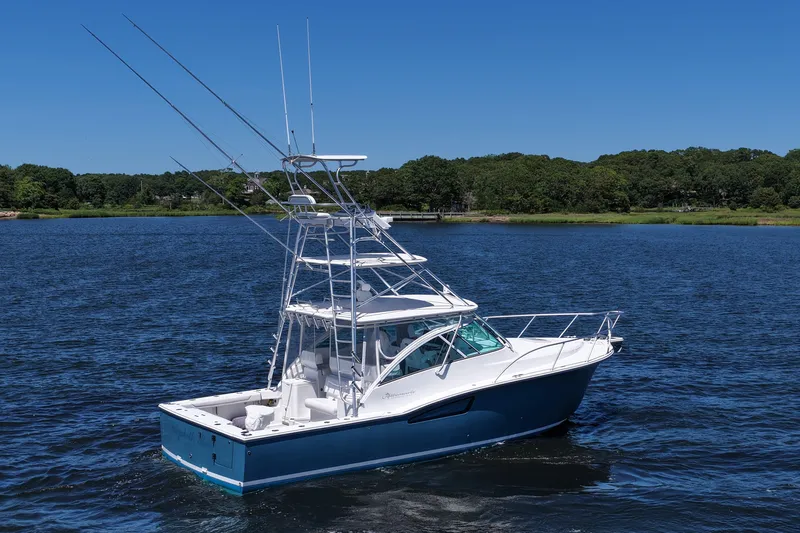  Yacht Photos Pics 2018 Albemarle 36 Express boat on a serene lake with lush green shoreline.