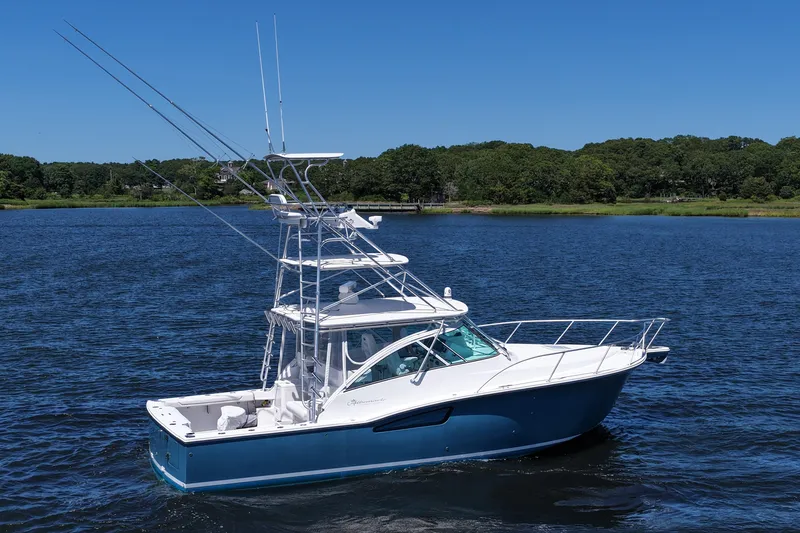  Yacht Photos Pics 2018 Albemarle 36 Express boat cruising on a serene lake under a clear blue sky.