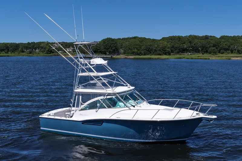  Yacht Photos Pics 2018 Albemarle 36 Express boat on a calm lake with lush green shoreline.