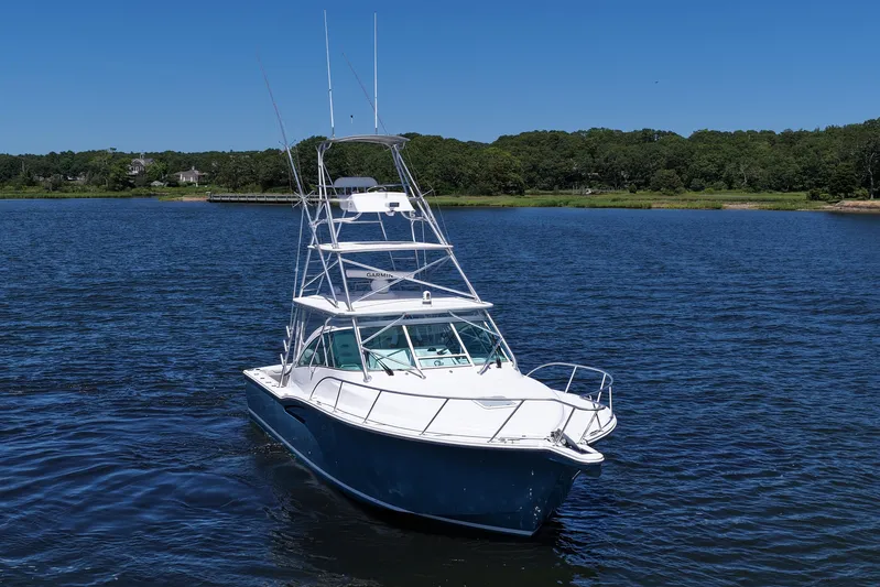  Yacht Photos Pics 2018 Albemarle 36 Express boat on calm water with lush green shoreline.