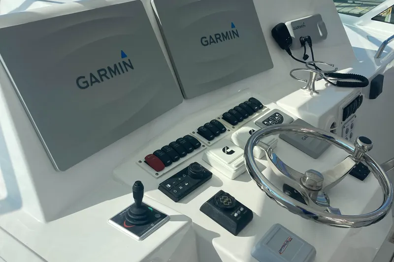  Yacht Photos Pics Control panel of 2018 Albemarle 36 Express with Garmin displays and steering wheel.