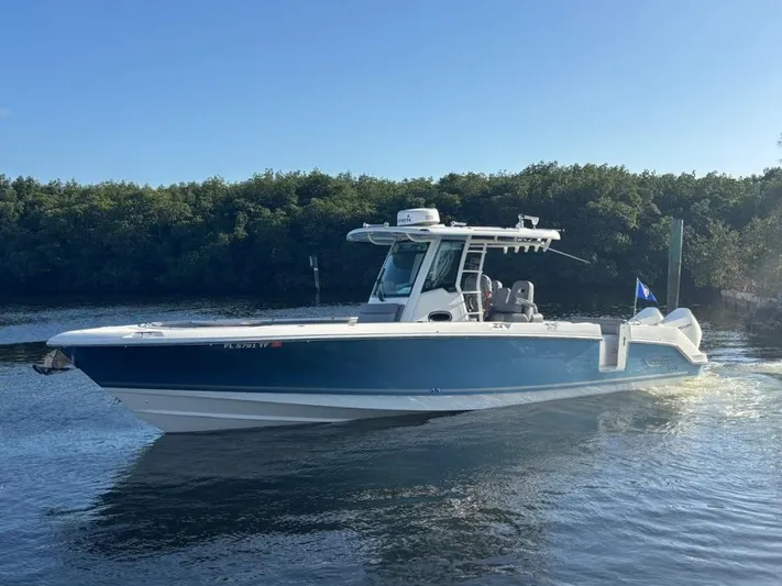  Yacht Photos Pics 2022 Boston Whaler 33 OUTRAGE boat on calm water.