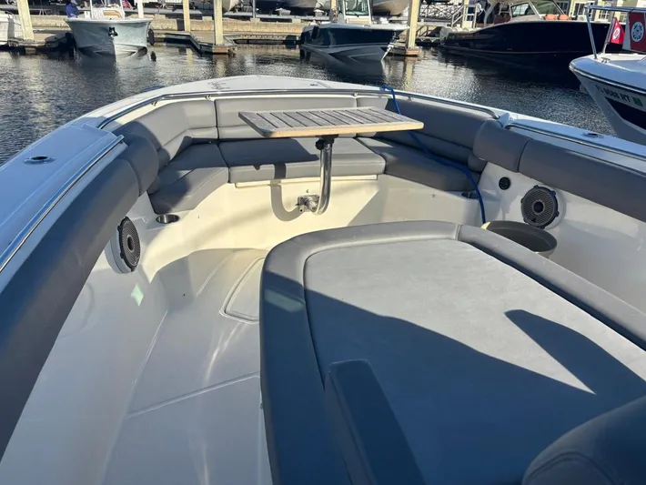  Yacht Photos Pics Boston Whaler 33 OUTRAGE 2022 with seating area and table in foreground.