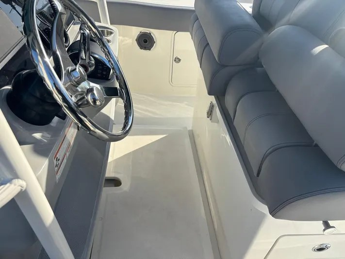  Yacht Photos Pics Interior of 2022 Boston Whaler 33 OUTRAGE with steering wheel and seats.