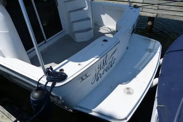  Yacht Photos Pics 1999 Mainship 350 Trawler docked, featuring spacious deck and "Just Breathe" inscription.