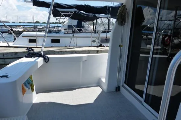  Yacht Photos Pics 1999 Mainship 350 Trawler deck view with docked boats in background.