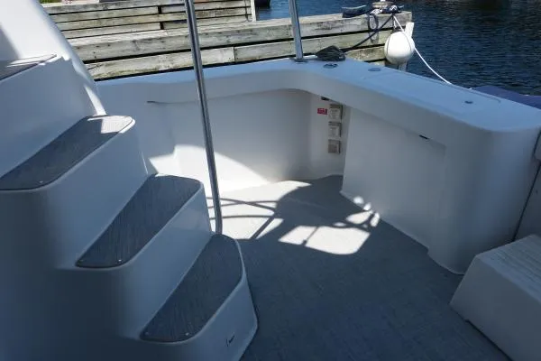  Yacht Photos Pics 1999 Mainship 350 Trawler deck with stairs and railing, docked by the water.