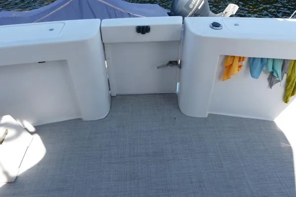  Yacht Photos Pics 1999 Mainship 350 Trawler deck with storage compartments and colorful towels.