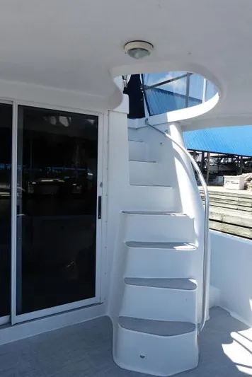  Yacht Photos Pics Spiral staircase on 1999 Mainship 350 Trawler, leading to upper deck.