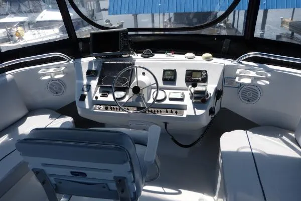  Yacht Photos Pics 1999 Mainship 350 Trawler helm with navigation equipment and steering wheel.