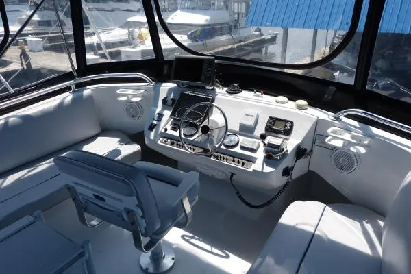  Yacht Photos Pics 1999 Mainship 350 Trawler helm with modern navigation equipment and comfortable seating.