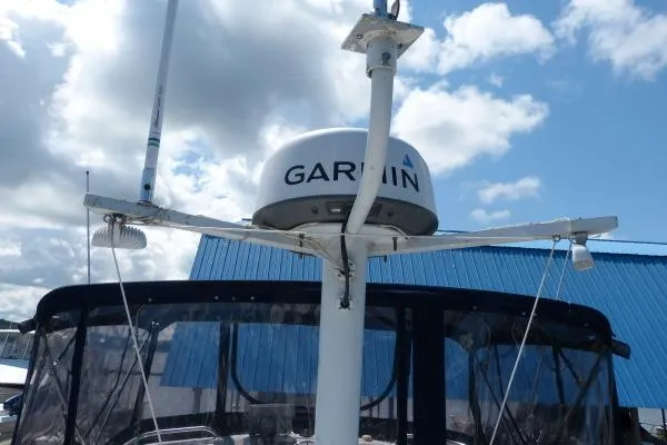  Yacht Photos Pics 1999 Mainship 350 Trawler with Garmin radar, blue canopy, and clear sky background.