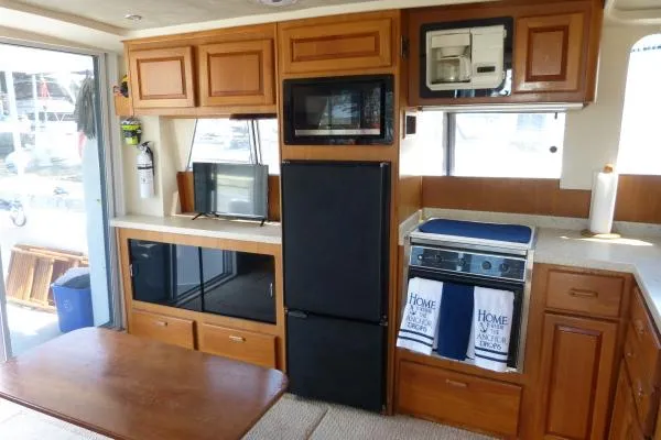 Yacht Photos Pics Interior of 1999 Mainship 350 Trawler with kitchen appliances and wooden cabinetry.
