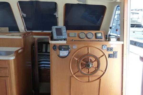  Yacht Photos Pics 1999 Mainship 350 Trawler helm with wooden wheel and navigation instruments.