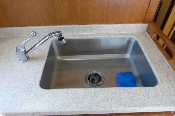  Yacht Photos Pics Stainless steel sink with faucet in 1999 Mainship 350 Trawler kitchen.