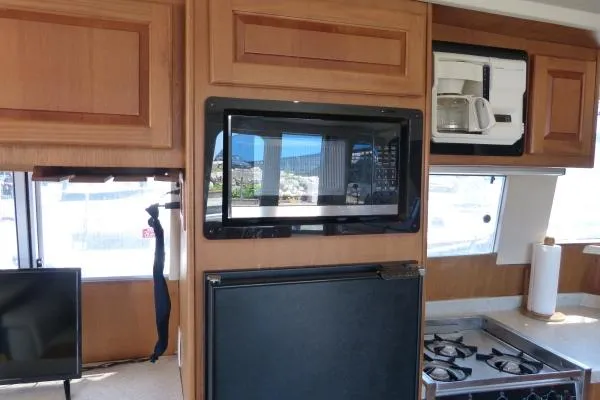 Yacht Photos Pics Interior of 1999 Mainship 350 Trawler with kitchen appliances and wooden cabinetry.
