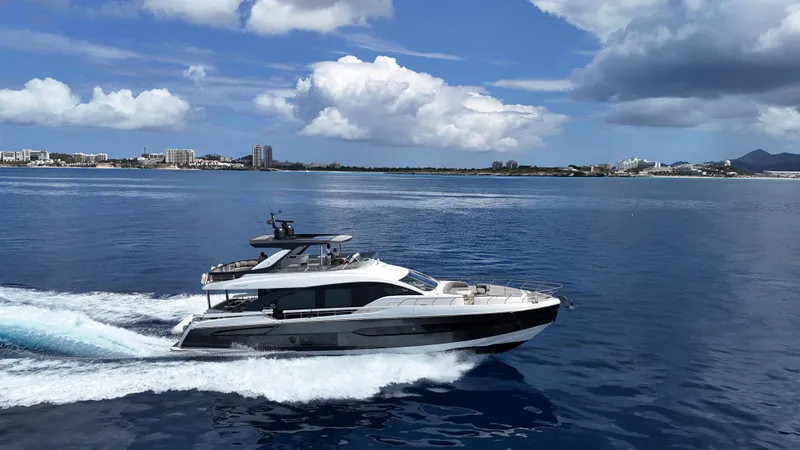  Yacht Photos Pics Luxury Azimut Fly 78 yacht cruising on open water under a partly cloudy sky.