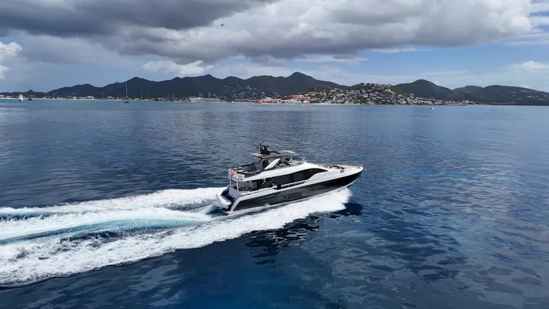  Yacht Photos Pics Azimut Fly 78 yacht cruising on open water, 2021 model, with scenic mountain backdrop.