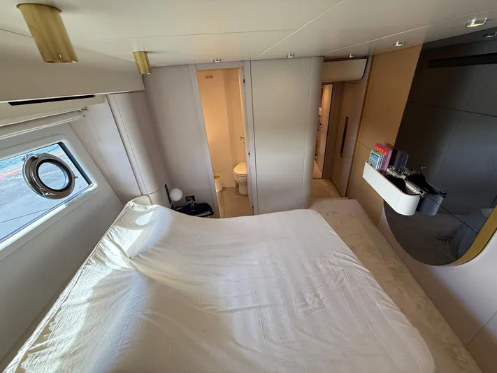  Yacht Photos Pics Luxurious bedroom interior of 2021 Azimut Fly 78 yacht with modern design and natural light.