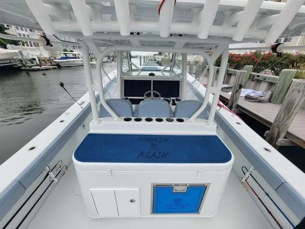  Yacht Photos Pics 2022 Yellowfin 42 Offshore boat docked, featuring spacious deck and seating area.