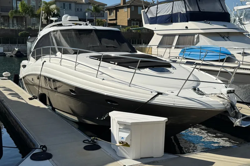  Yacht Photos Pics 2006 Sea Ray 48 Sundancer yacht docked at marina, featuring sleek design and modern amenities.