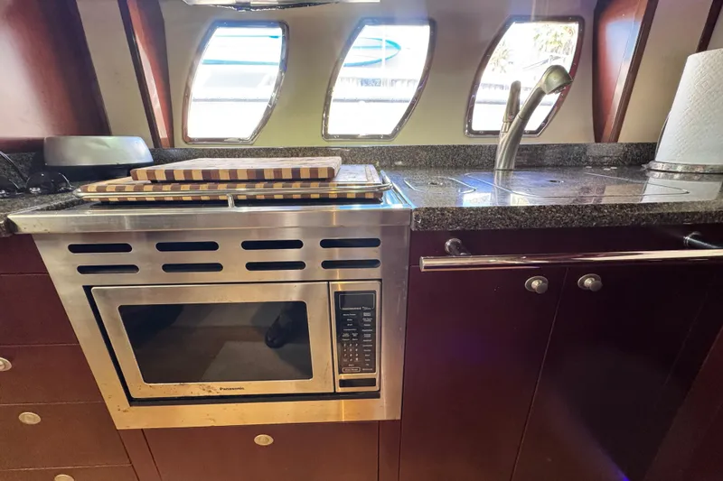  Yacht Photos Pics Kitchen area of 2006 Sea Ray 48 Sundancer with microwave, sink, and countertop.