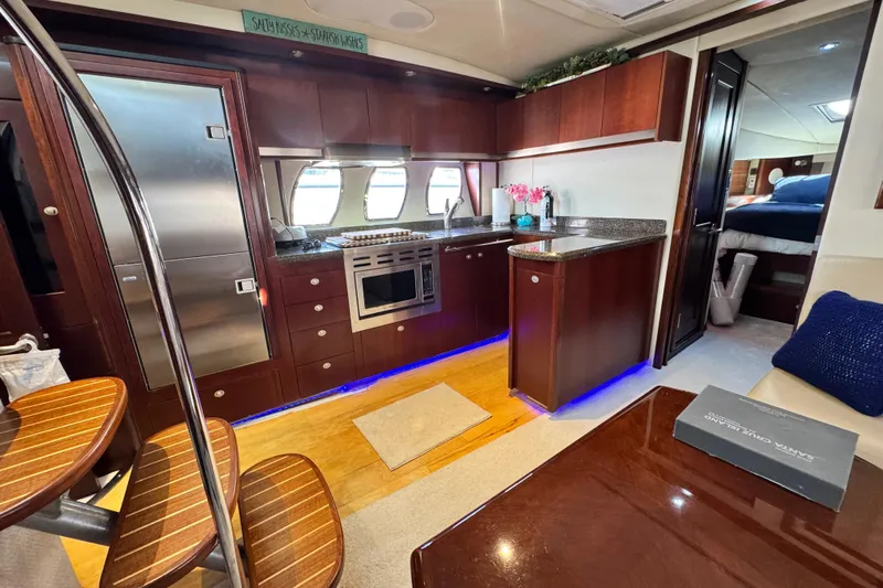  Yacht Photos Pics Luxurious 2006 Sea Ray 48 Sundancer yacht interior with modern kitchen and elegant wood finishes.