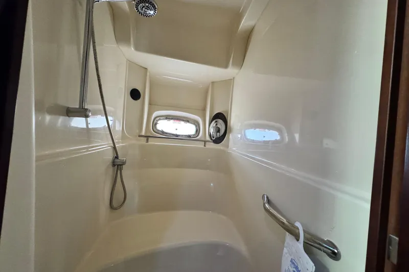  Yacht Photos Pics Shower area inside 2006 Sea Ray 48 Sundancer yacht, featuring sleek design and porthole window.