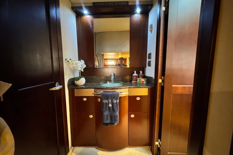  Yacht Photos Pics Luxurious bathroom interior of 2006 Sea Ray 48 Sundancer yacht with elegant wood cabinetry.