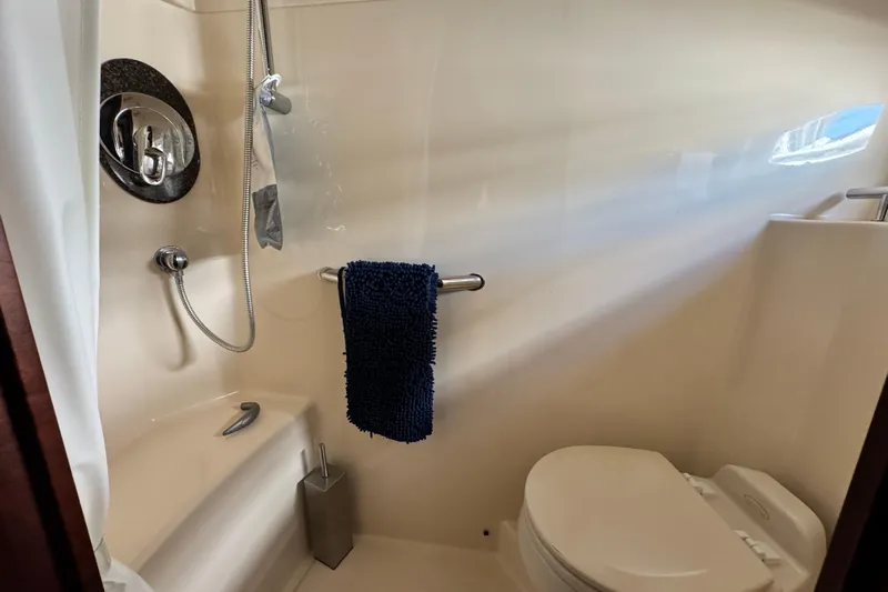  Yacht Photos Pics Bathroom interior of 2006 Sea Ray 48 Sundancer yacht, featuring shower and toilet.