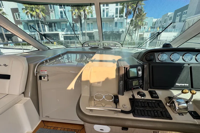  Yacht Photos Pics Helm of 2006 Sea Ray 48 Sundancer with navigation equipment and luxurious seating.