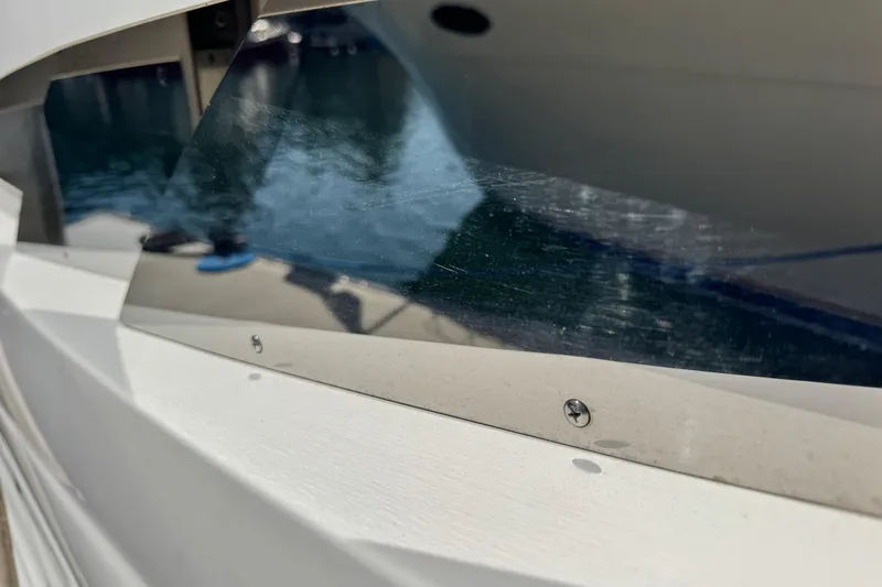  Yacht Photos Pics Close-up of 2006 Sea Ray 48 Sundancer boat window reflecting water.