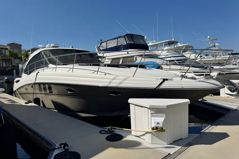  Yacht Photos Pics 2006 Sea Ray 48 Sundancer yacht docked at marina under clear blue sky.