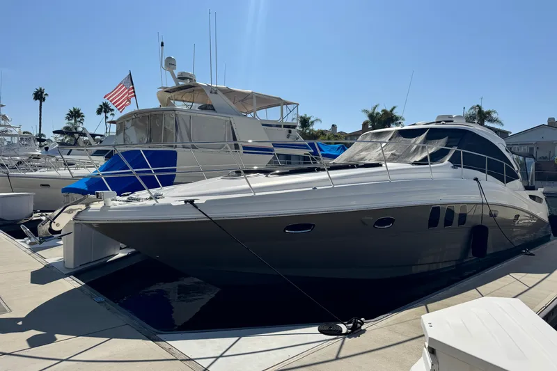  Yacht Photos Pics 2006 Sea Ray 48 Sundancer yacht docked at marina under clear blue sky.