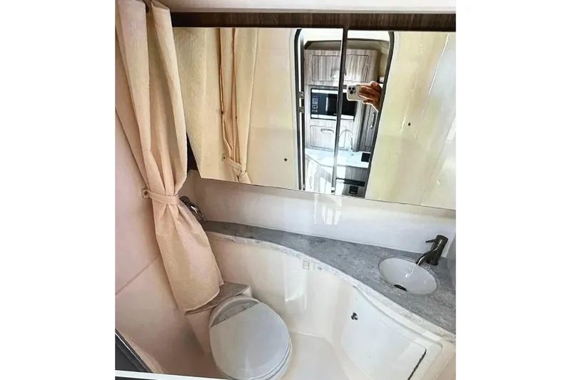  Yacht Photos Pics Bathroom interior of 2022 Regal 28 Express boat with mirror and sink.