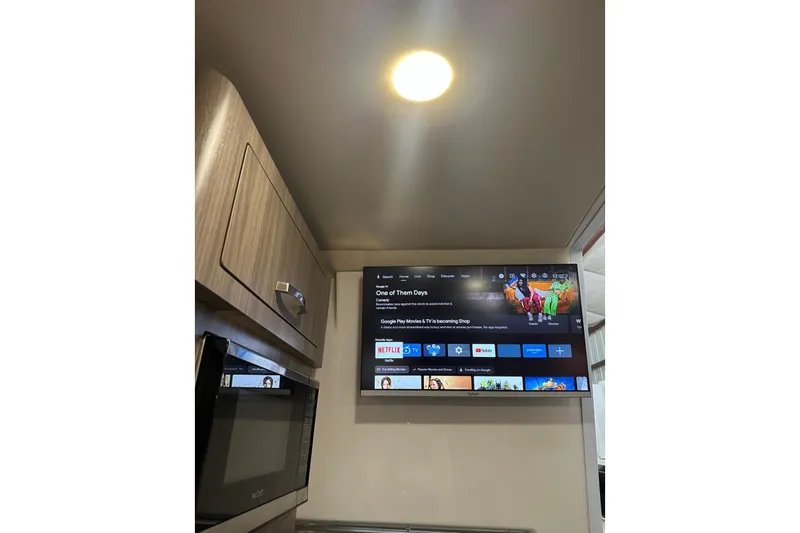  Yacht Photos Pics Interior of 2022 Regal 28 Express with TV and microwave in cabin.