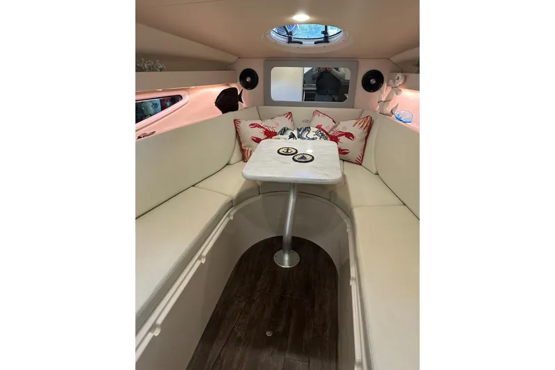  Yacht Photos Pics 2022 Regal 28 Express cabin interior with cozy seating and nautical decor.