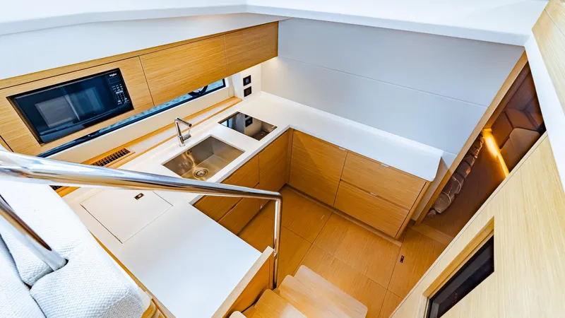 Available Now Yacht Photos Pics 2024 Pardo Yachts GT52 interior kitchen with modern design and wooden cabinetry.