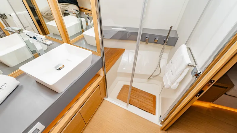 Available Now Yacht Photos Pics Luxurious bathroom in 2024 Pardo Yachts GT52, featuring modern sink and shower.