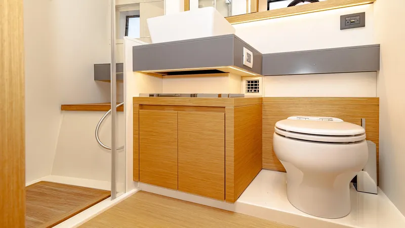 Available Now Yacht Photos Pics Modern bathroom in 2024 Pardo Yachts GT52, featuring sleek wood cabinetry and elegant fixtures.