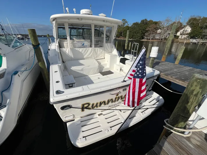  Yacht Photos Pics 2001 Tiara Yachts 4100 Open docked with American flag, rear view.