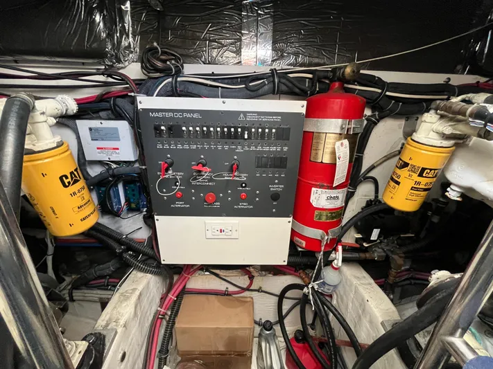  Yacht Photos Pics Engine room of 2001 Tiara Yachts 4100 Open with control panel and fire extinguisher.