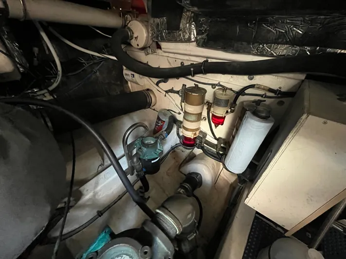  Yacht Photos Pics Engine room of a 2001 Tiara Yachts 4100 Open, showcasing mechanical components and filters.