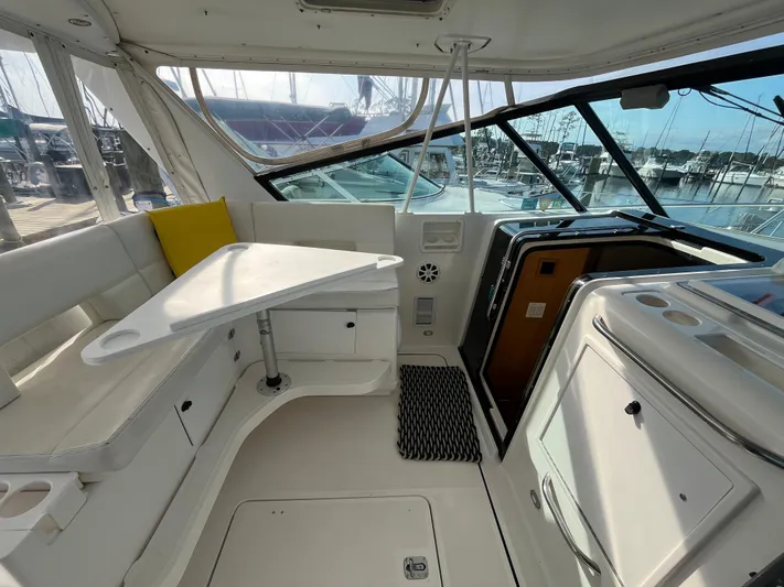  Yacht Photos Pics 2001 Tiara Yachts 4100 Open interior with seating and table, docked at marina.