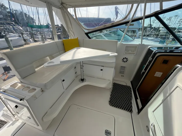  Yacht Photos Pics 2001 Tiara Yachts 4100 Open interior with seating and table, docked at marina.