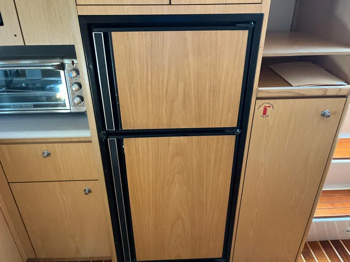  Yacht Photos Pics 2001 Tiara Yachts 4100 Open interior with wooden cabinetry and built-in appliances.