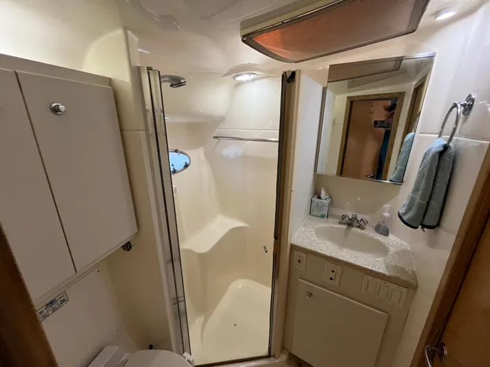  Yacht Photos Pics Bathroom interior of 2001 Tiara Yachts 4100 Open, featuring shower and vanity.