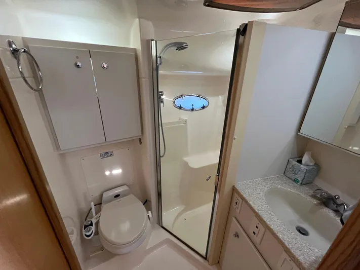  Yacht Photos Pics Bathroom interior of 2001 Tiara Yachts 4100 Open, featuring shower, toilet, and sink.