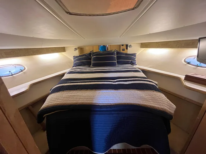  Yacht Photos Pics 2001 Tiara Yachts 4100 Open cabin interior with striped bedding and porthole windows.